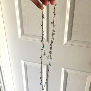 Long gold necklace with blue and green beads